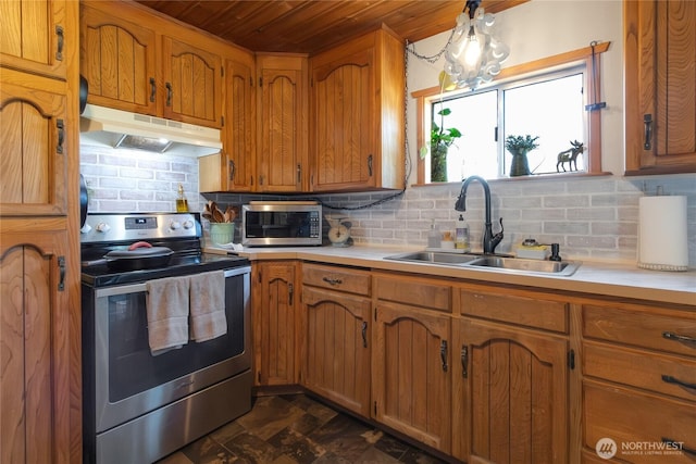 kitchen with wood ceiling, brown cabinets, a sink, appliances with stainless steel finishes, and under cabinet range hood
