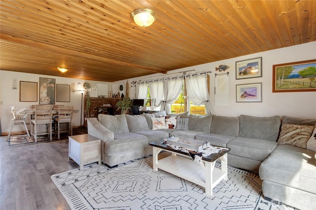 living area with wood finished floors and wood ceiling