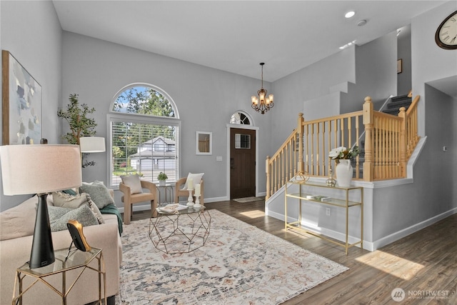 18431 Newport Dr, Arlington, WA 98223 - foyer featuring stairway, a chandelier, wood finished floors, baseboards, and a high ceiling