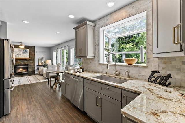 18431 Newport Dr, Arlington, WA 98223 - kitchen with a sink, appliances with stainless steel finishes, gray cabinets, open floor plan, and dark wood-style flooring
