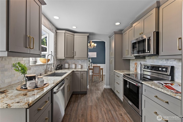 18431 Newport Dr, Arlington, WA 98223 - kitchen with stainless steel appliances, a sink, gray cabinets, dark wood-style flooring, and backsplash