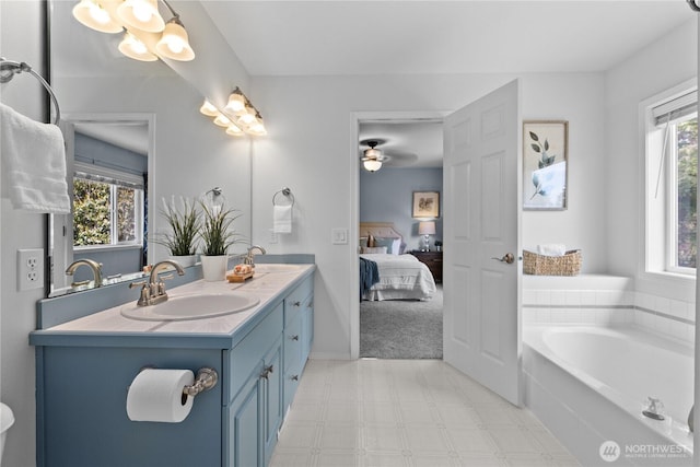 18431 Newport Dr, Arlington, WA 98223 - ensuite bathroom featuring double vanity, tile patterned floors, plenty of natural light, and a bath