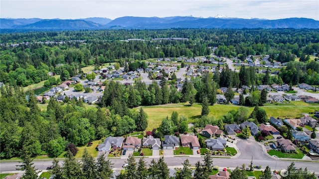 18431 Newport Dr, Arlington, WA 98223 - aerial view of residential area featuring a mountainous background and a heavily wooded area