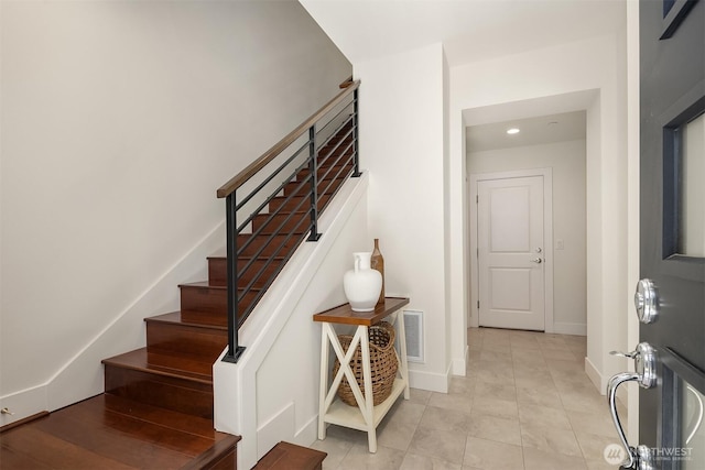 stairs featuring recessed lighting, baseboards, visible vents, and tile patterned flooring