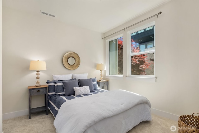 carpeted bedroom with baseboards and visible vents