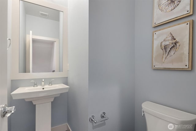 bathroom featuring toilet and visible vents