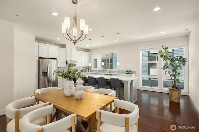 dining area featuring recessed lighting, baseboards, a notable chandelier, and dark wood-style floors