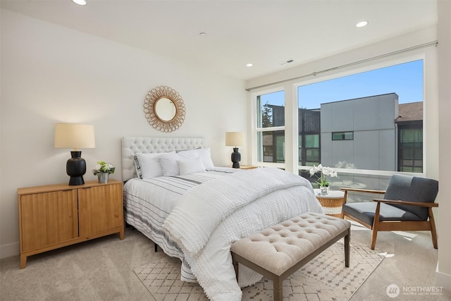 bedroom with recessed lighting and light carpet