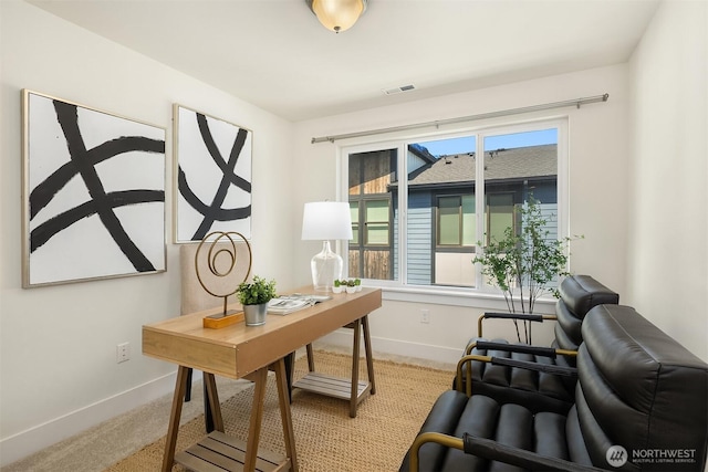 carpeted office space featuring baseboards and visible vents