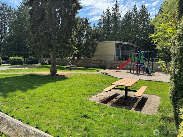 view of yard featuring fence and playground community