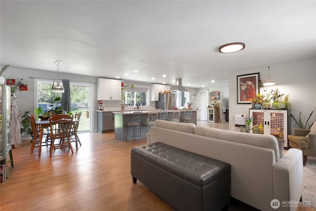 living area featuring recessed lighting and light wood-style flooring