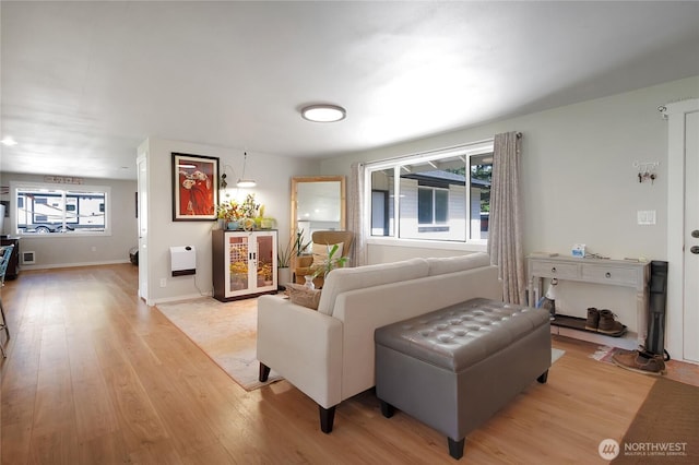 living room with light wood-style flooring and baseboards