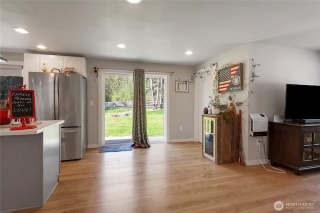interior space featuring light wood finished floors, recessed lighting, and baseboards
