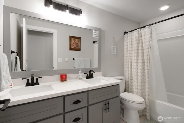 bathroom with toilet, double vanity, a sink, and shower / tub combo with curtain