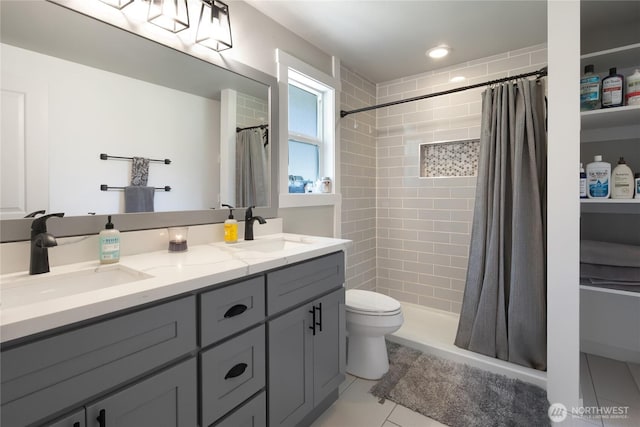 bathroom featuring a stall shower, toilet, and a sink