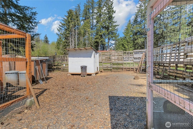 view of yard with fence and an outbuilding
