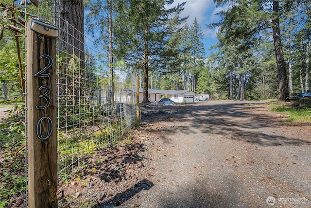 view of road with dirt driveway