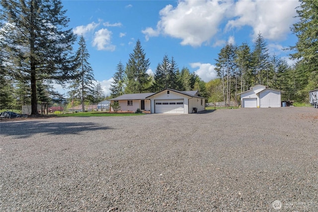 view of front of house with a garage and fence