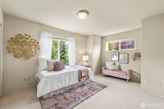 carpeted bedroom featuring baseboards
