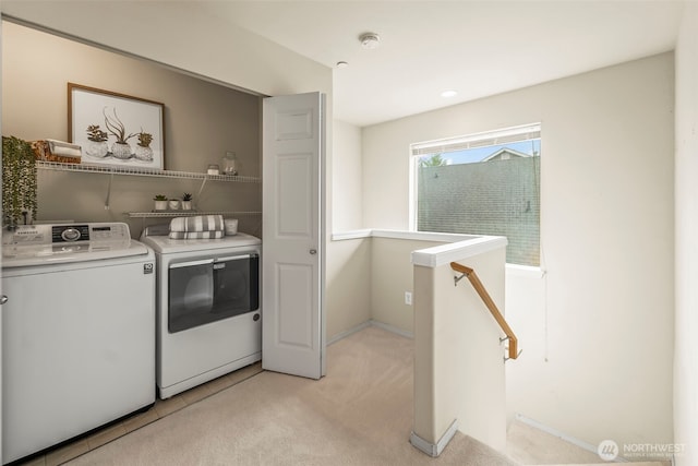 laundry room featuring washer and dryer, laundry area, and light carpet