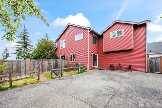 back of house featuring a patio area and a fenced backyard