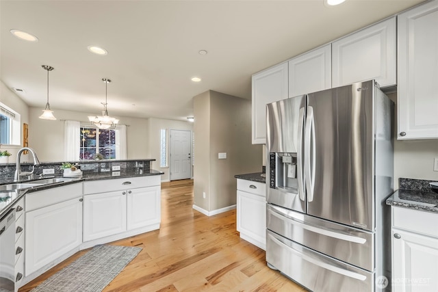 kitchen featuring light wood finished floors, a sink, stainless steel refrigerator with ice dispenser, white cabinets, and recessed lighting