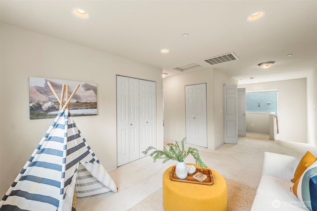 rec room with recessed lighting, light carpet, and visible vents