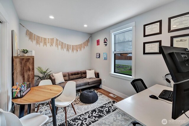 office area with baseboards, recessed lighting, wood finished floors, and visible vents