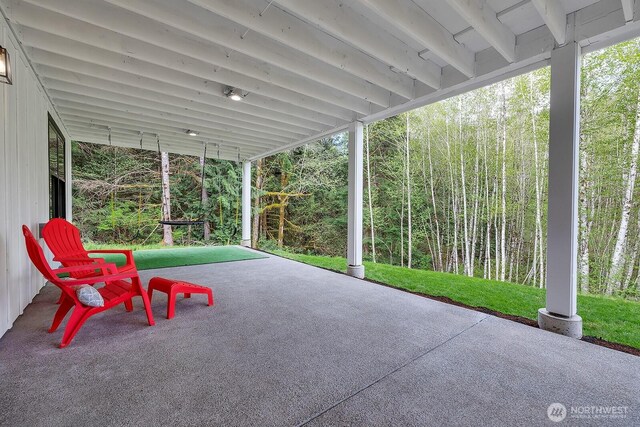 view of patio / terrace featuring a forest view
