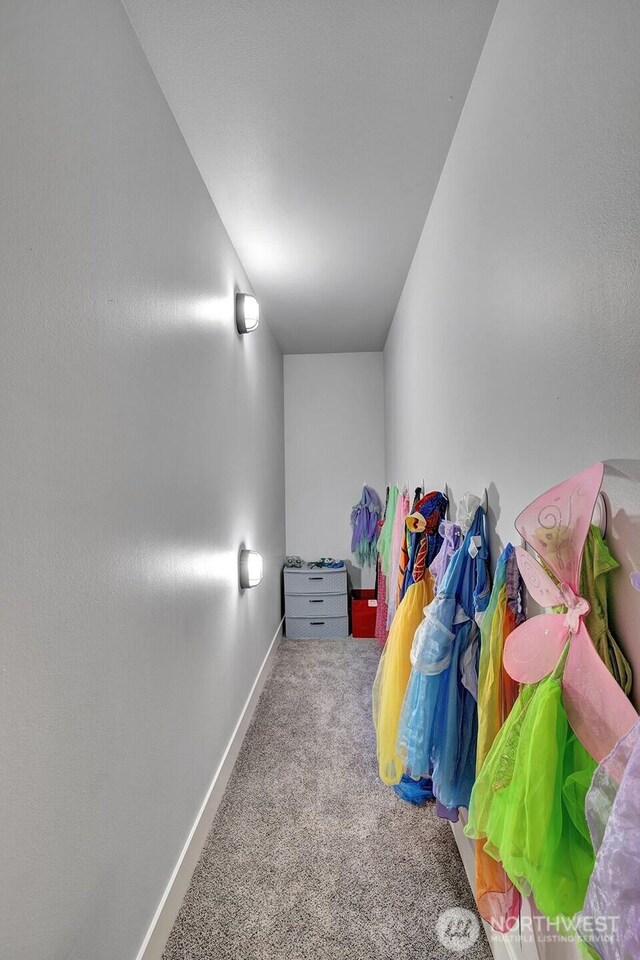 hall featuring carpet floors and baseboards