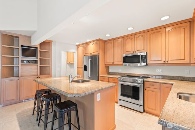 1208 N 20th Ave, Yakima, WA 98902 - kitchen featuring light stone counters, a breakfast bar area, a sink, appliances with stainless steel finishes, and recessed lighting