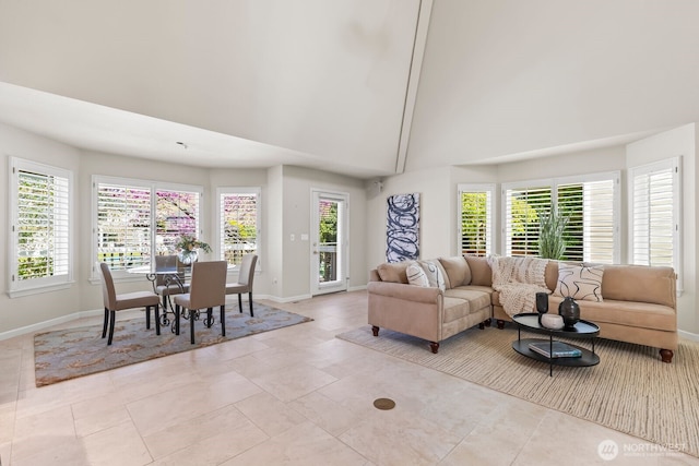 1208 N 20th Ave, Yakima, WA 98902 - living area featuring light tile patterned flooring, high vaulted ceiling, and baseboards