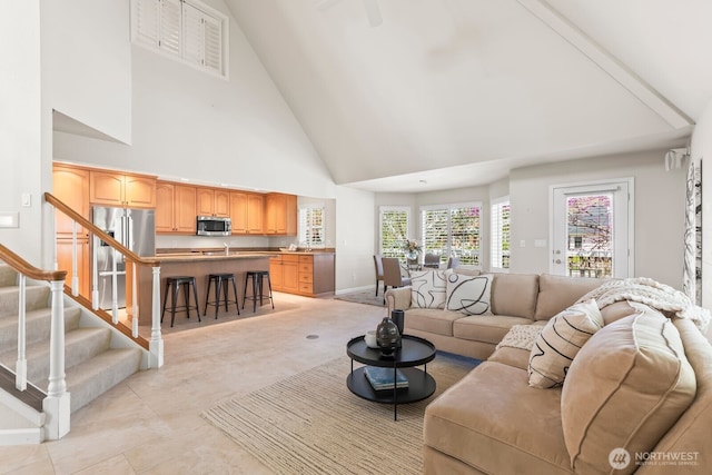 1208 N 20th Ave, Yakima, WA 98902 - living area featuring stairway, light tile patterned floors, baseboards, visible vents, and high vaulted ceiling