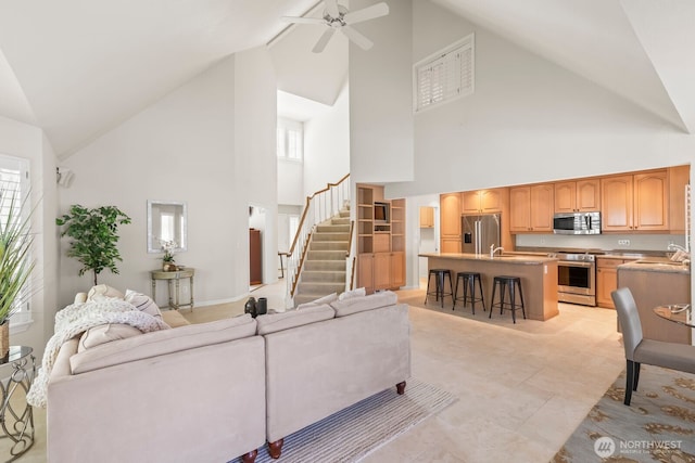1208 N 20th Ave, Yakima, WA 98902 - living room featuring a healthy amount of sunlight, high vaulted ceiling, a ceiling fan, and stairs