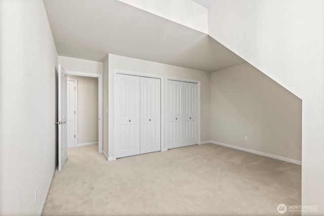 1208 N 20th Ave, Yakima, WA 98902 - unfurnished bedroom featuring baseboards, light colored carpet, and multiple closets