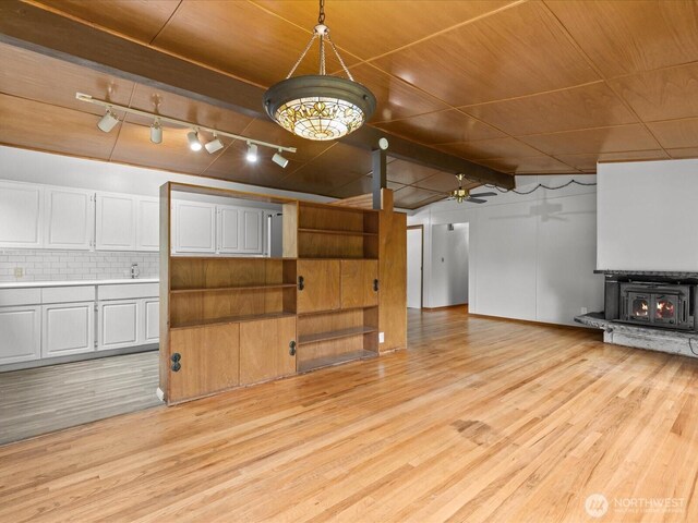 2909 SW 116th St, Burien, WA 98146 - unfurnished living room featuring light wood-style floors, track lighting, ceiling fan, lofted ceiling, and a sink