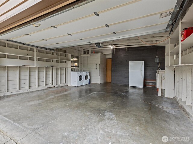 2909 SW 116th St, Burien, WA 98146 - garage featuring freestanding refrigerator, independent washer and dryer, and a garage door opener