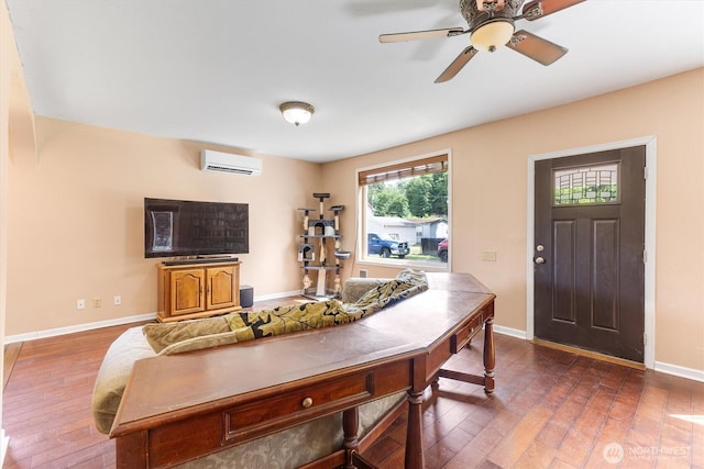 56 Shear St SW, Castle Rock, WA 98611 - living room with a wall mounted AC, hardwood / wood-style flooring, baseboards, and a ceiling fan