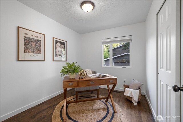 home office featuring baseboards, dark wood finished floors, and a textured ceiling