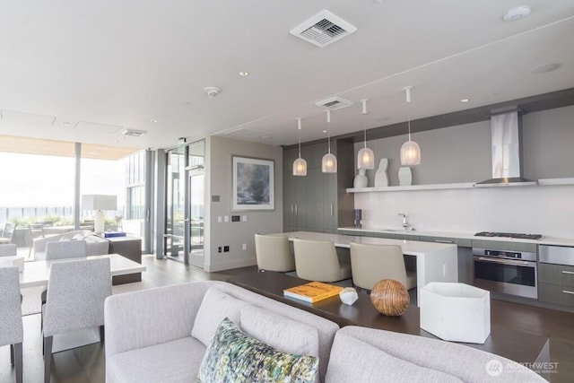 121 Stewart St Unit 905, Seattle, WA 98121 - living room with expansive windows, dark wood-type flooring, and baseboards