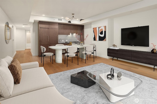 121 Stewart St Unit 905, Seattle, WA 98121 - living area featuring light wood-style flooring, baseboards, and recessed lighting