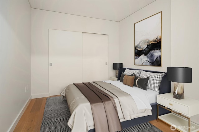 121 Stewart St Unit 905, Seattle, WA 98121 - bedroom featuring wood finished floors, a closet, and baseboards