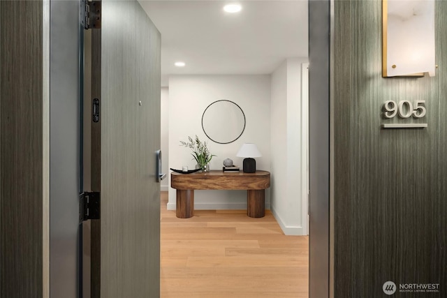 121 Stewart St Unit 905, Seattle, WA 98121 - hall with baseboards, light wood-type flooring, and recessed lighting