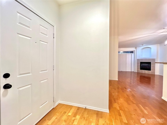 interior space with baseboards and light wood-style flooring