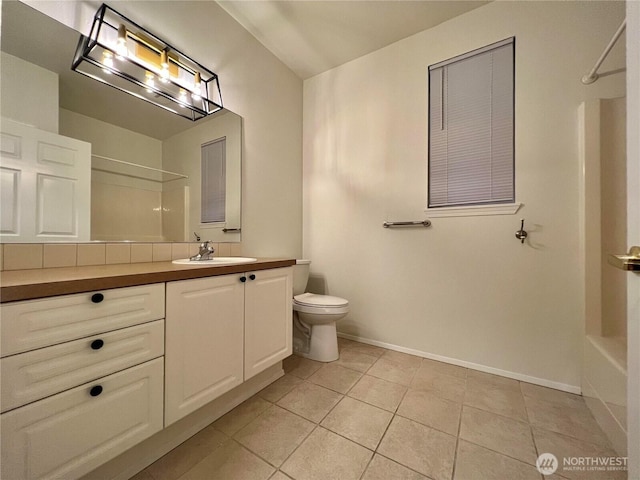 bathroom with vanity, bathing tub / shower combination, toilet, baseboards, and tile patterned flooring