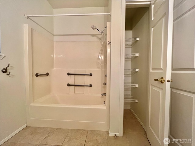 bathroom featuring shower / tub combination, tile patterned floors, and baseboards