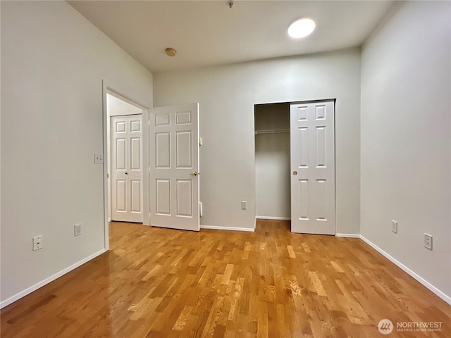 unfurnished bedroom featuring light wood-type flooring and baseboards