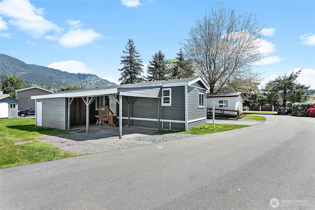 manufactured / mobile home with a carport and a mountain view