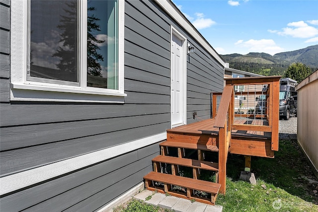 view of home's exterior featuring a deck with mountain view