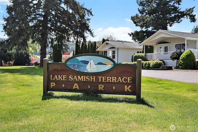 community sign featuring a lawn